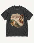 Black washed T-shirt with Corgi Divine Timing Still Loading Creation Parody front artwork