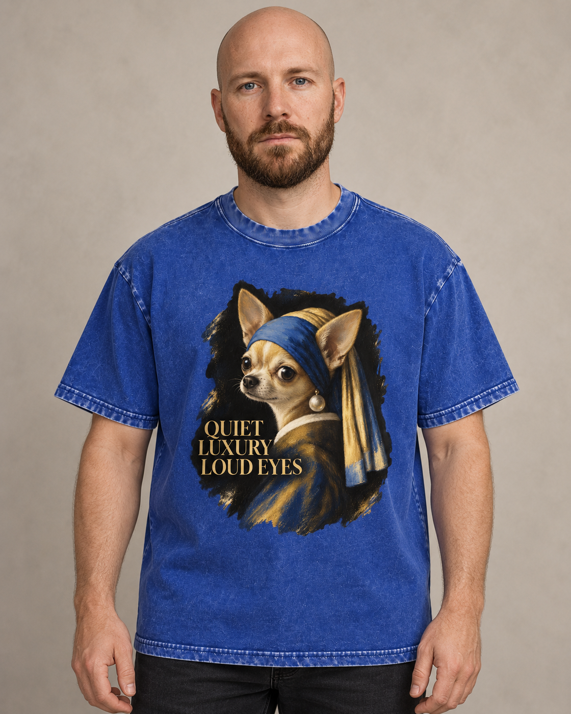 Adult model wears Royal Blue Chihuahua Quiet Luxury Loud Eyes Pearl Earring Portrait washed T-shirt in a warm studio portrai