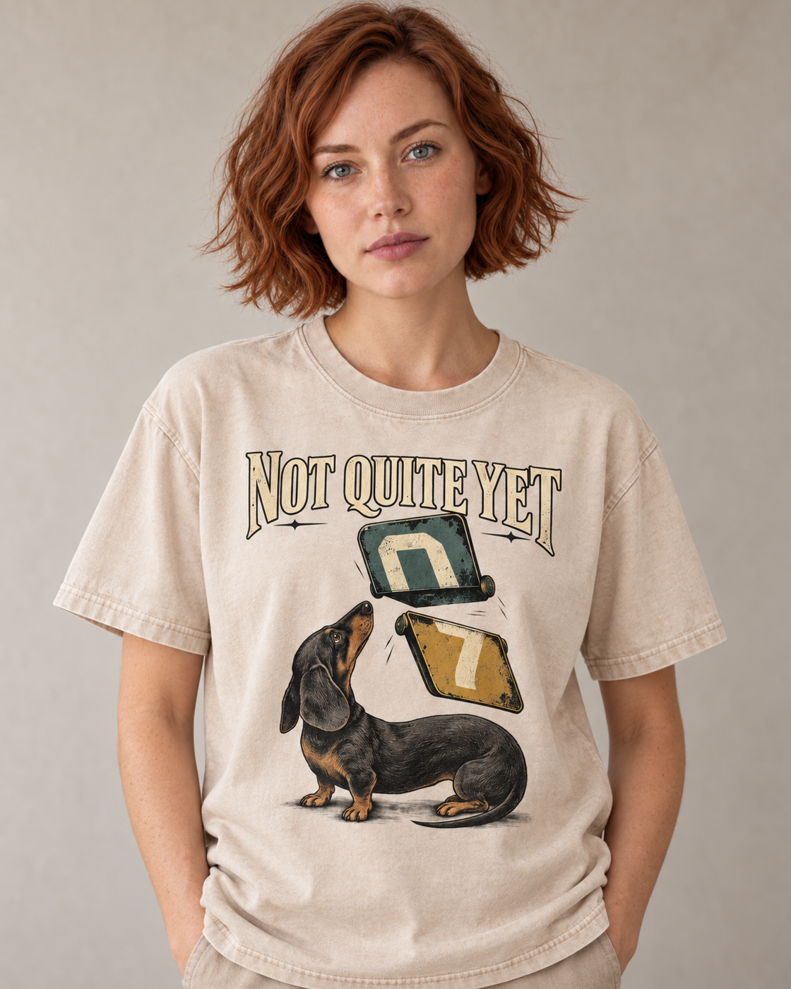 Adult model wears Apricot Dachshund Not Quite Yet Flip Cards washed T-shirt in a warm studio portrait