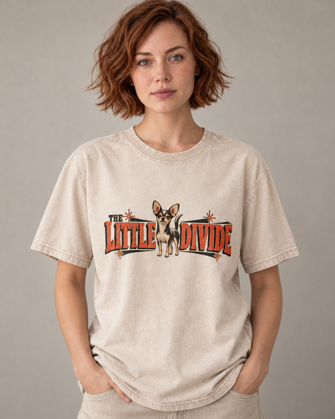 Adult model wears Apricot Chihuahua The Little Divide Retro Sign washed T-shirt in a warm studio portrait