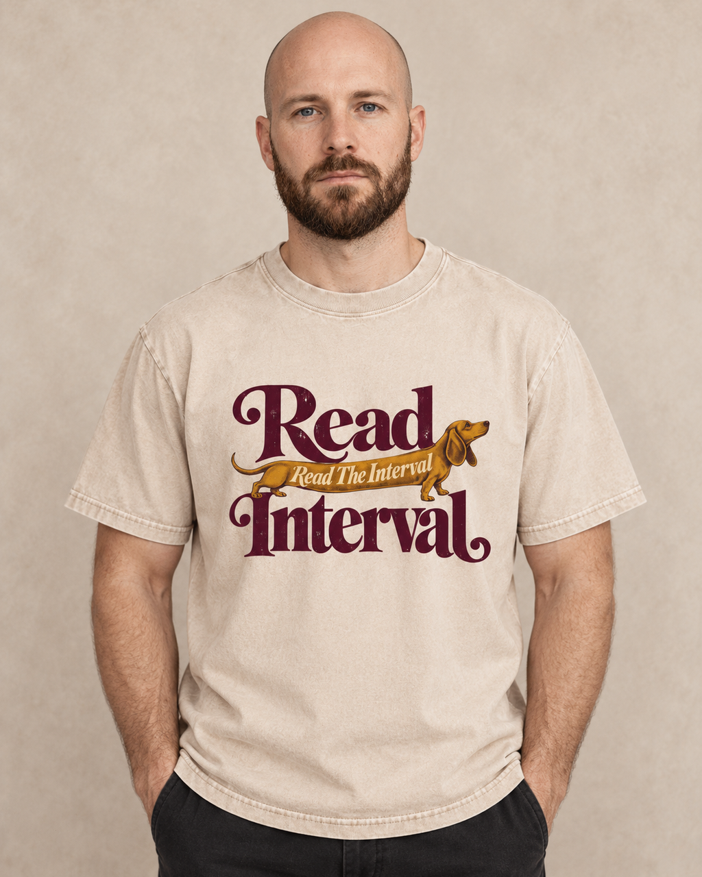 Adult model wears Apricot Dachshund Read The Interval Typographic washed T-shirt in a warm studio portrait