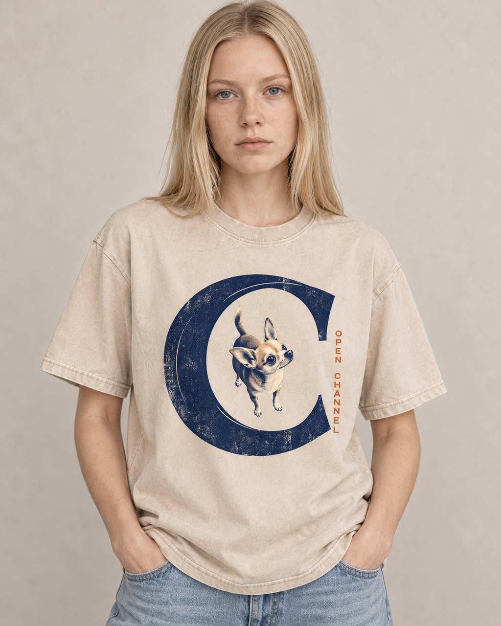 Adult model wears Apricot Chihuahua Open Channel washed T-shirt in a warm studio portrait