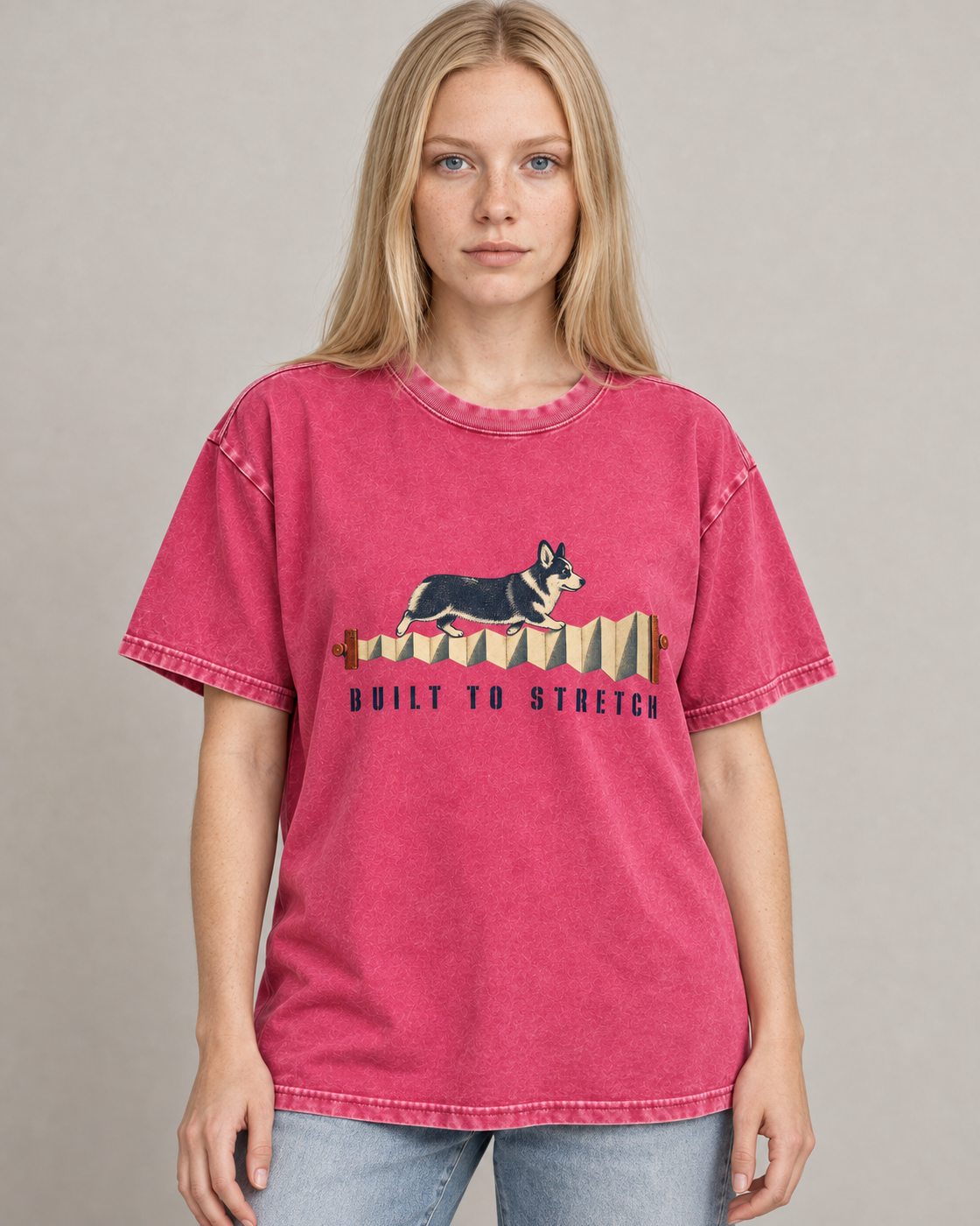 Adult model wears Fuchsia Corgi Built to Stretch Accordion washed T-shirt in a warm studio portrait