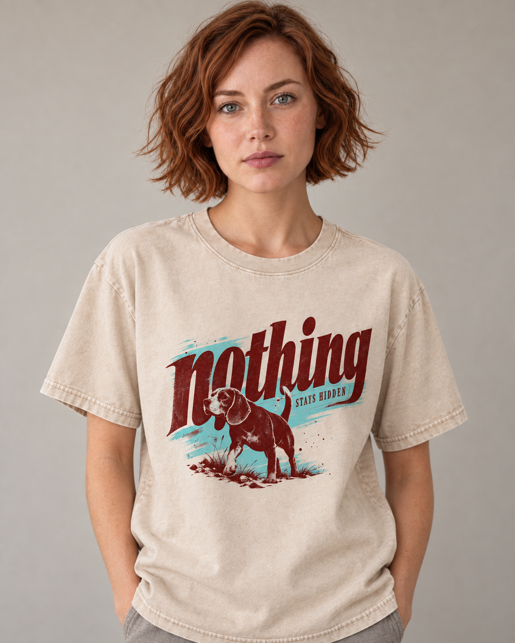 Adult model wears Apricot Beagle Nothing Stays Hidden washed T-shirt in a warm studio portrait