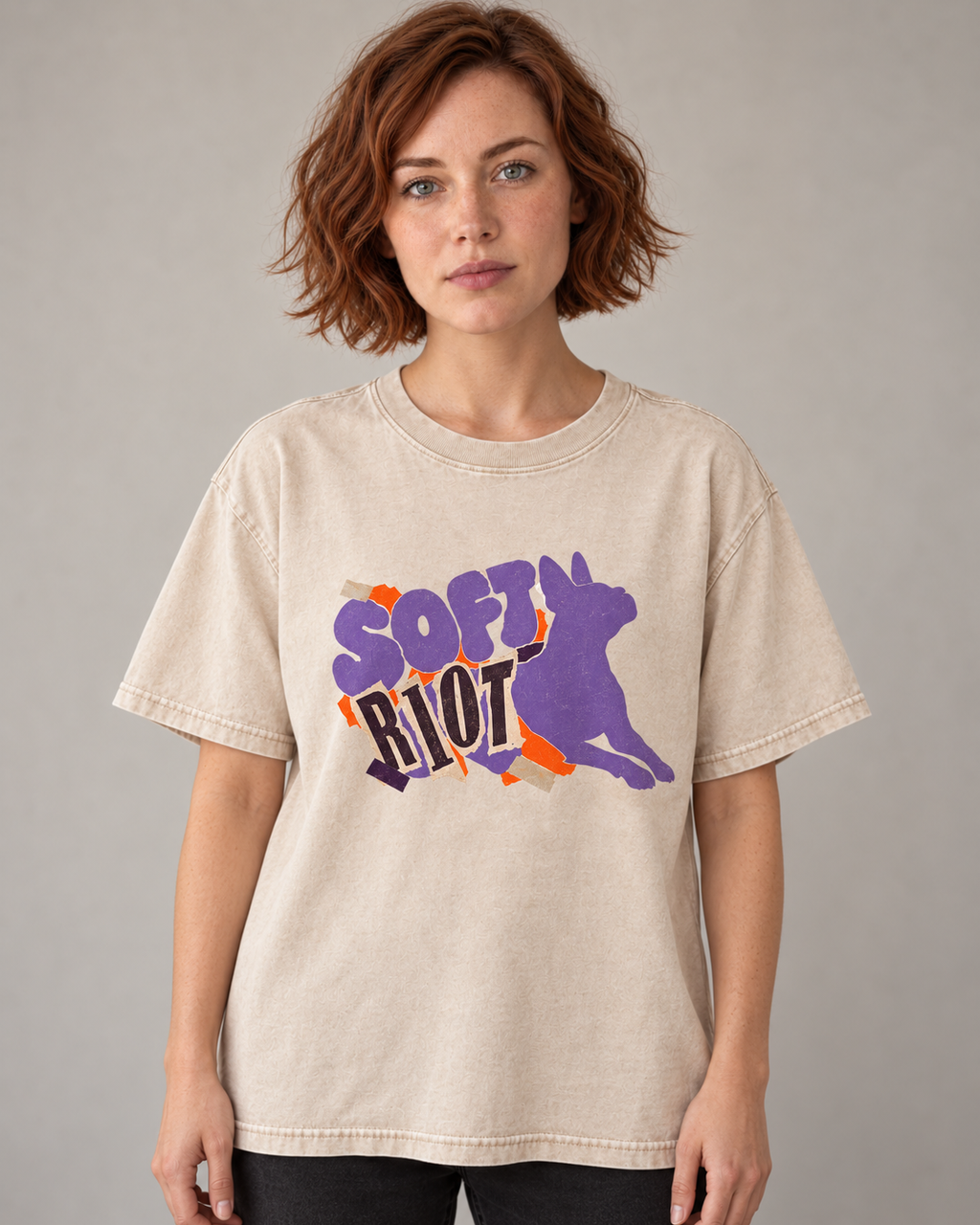 Adult model wears Apricot Boston Terrier Soft Riot washed T-shirt in a warm studio portrait
