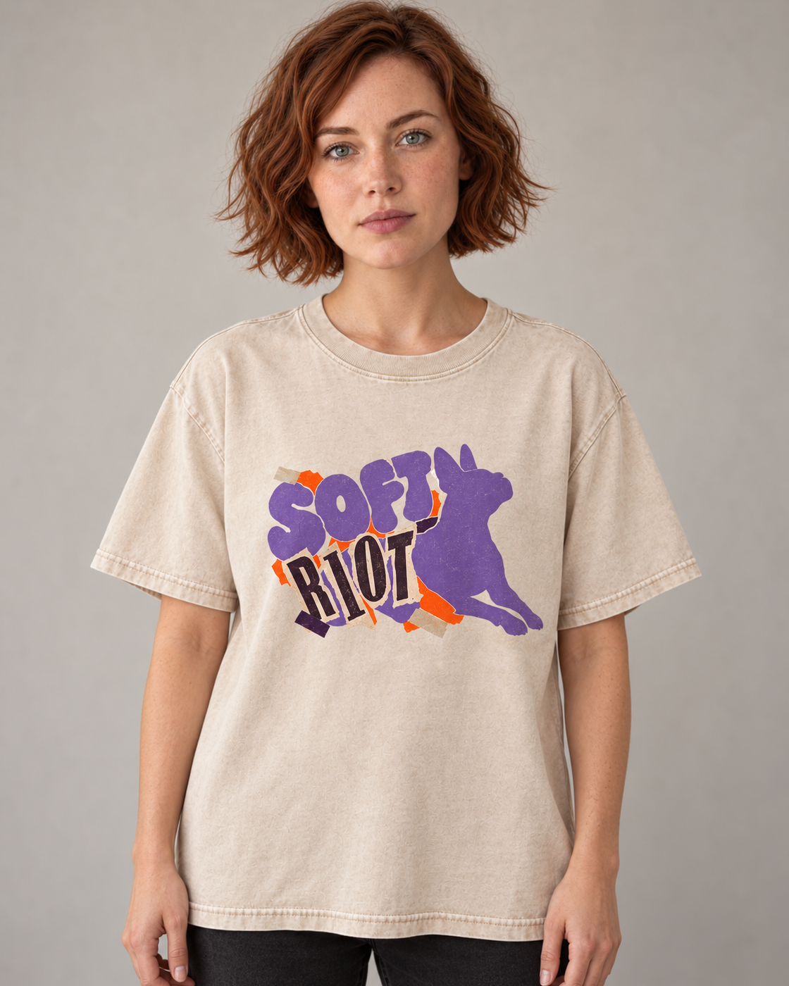 Adult model wears Apricot Boston Terrier Soft Riot washed T-shirt in a warm studio portrait