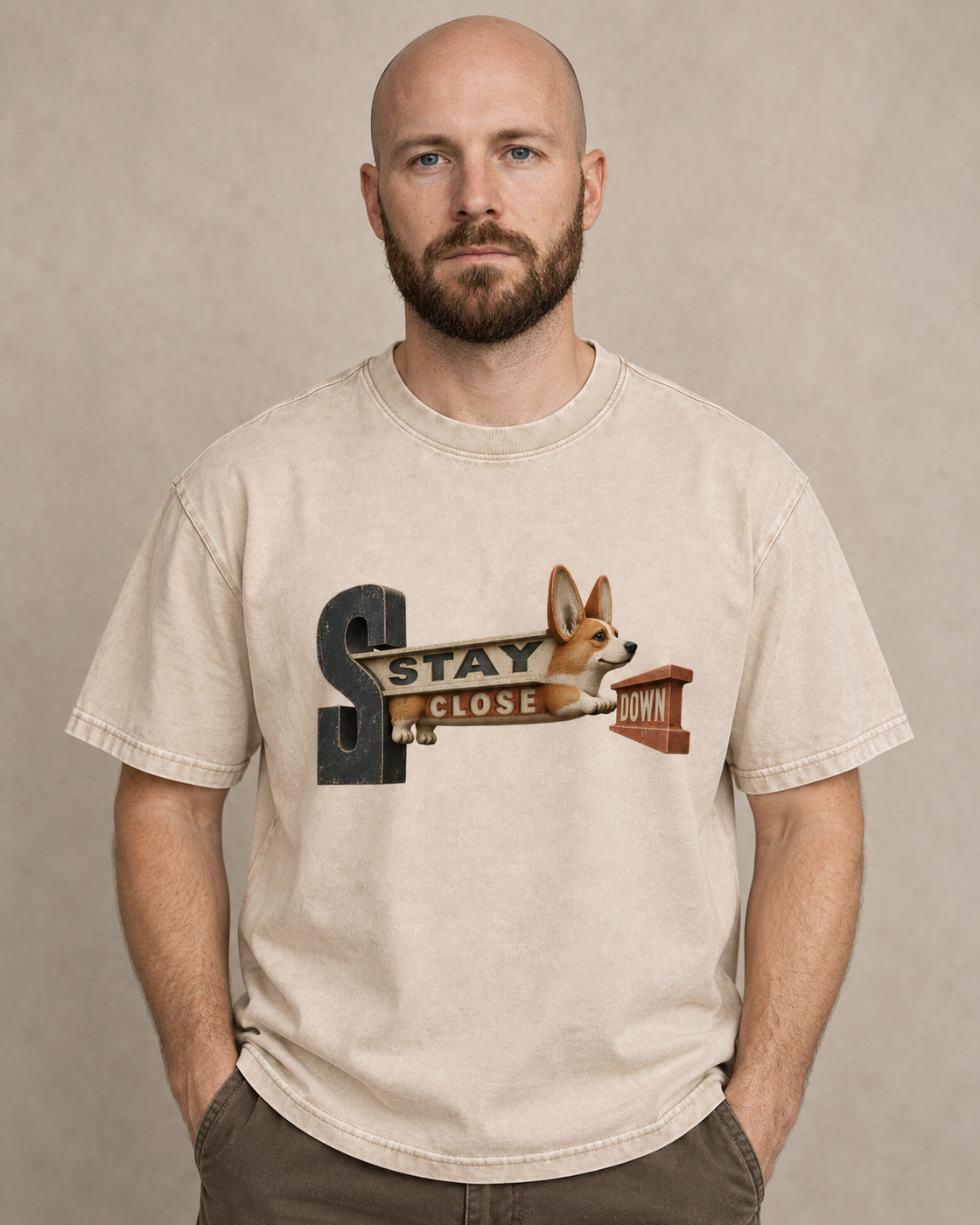Adult model wears Apricot Corgi Stay Close Down Sign washed T-shirt in a warm studio portrait