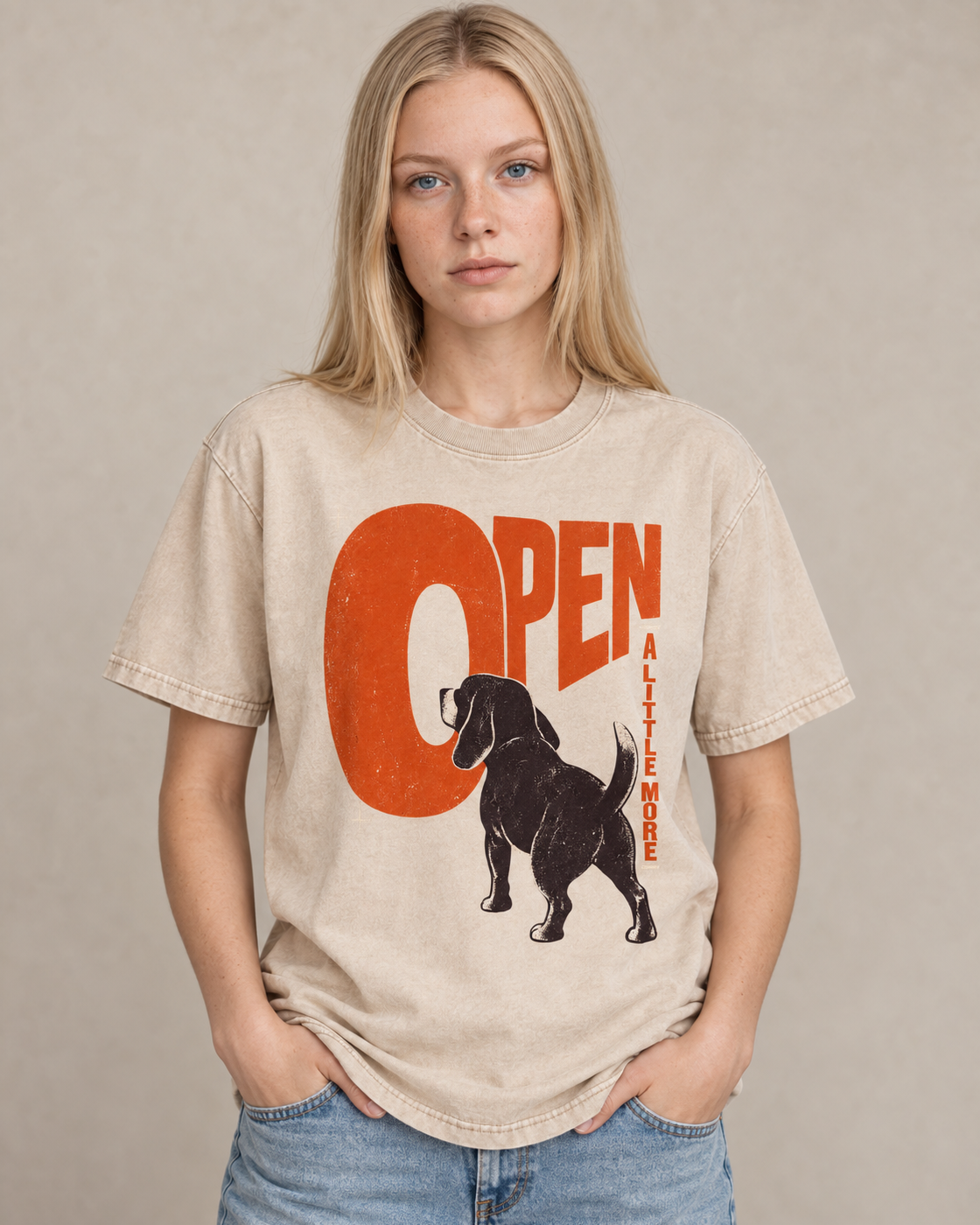 Adult model wears Apricot Beagle Open A Little More washed T-shirt in a warm studio portrait