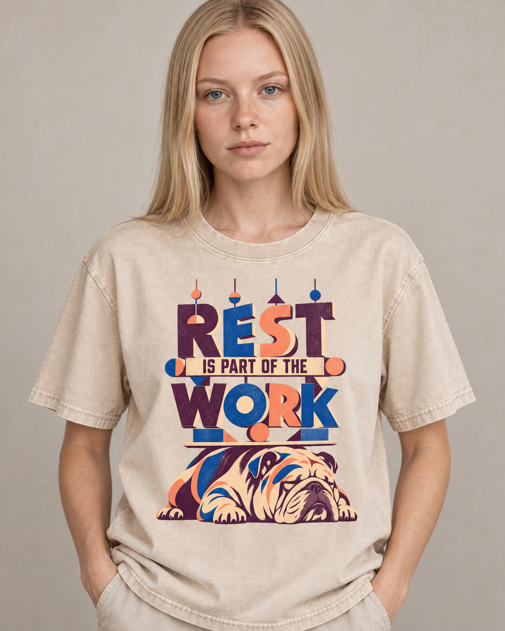 Adult model wears Apricot English Bulldog Rest Is Part of the Work Geometric washed T-shirt in a warm studio portrait