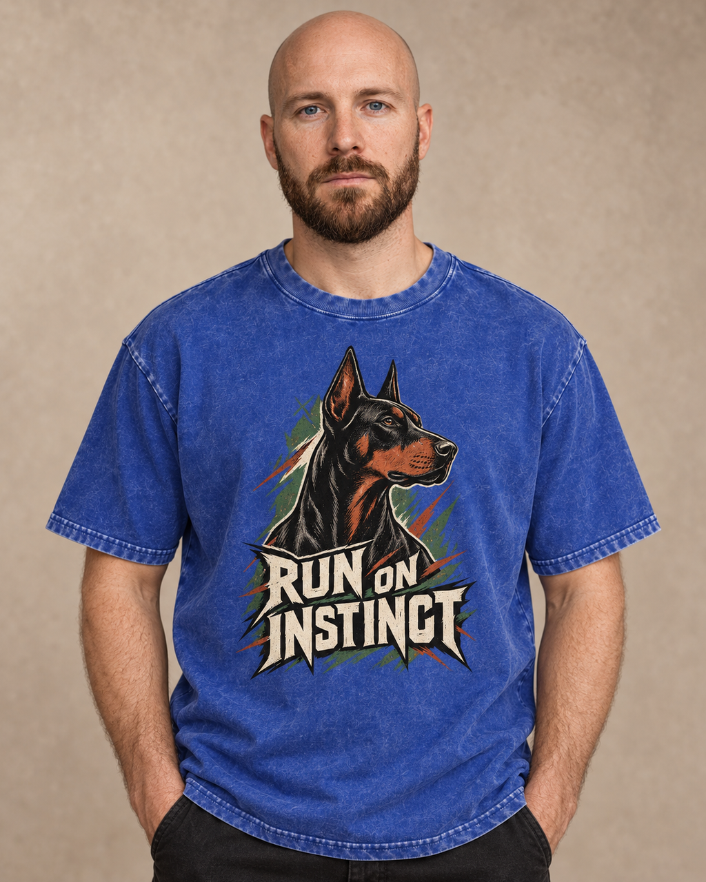 Adult model wears Royal Blue Doberman Run on Instinct Brush Slash washed T-shirt in a warm studio portrait