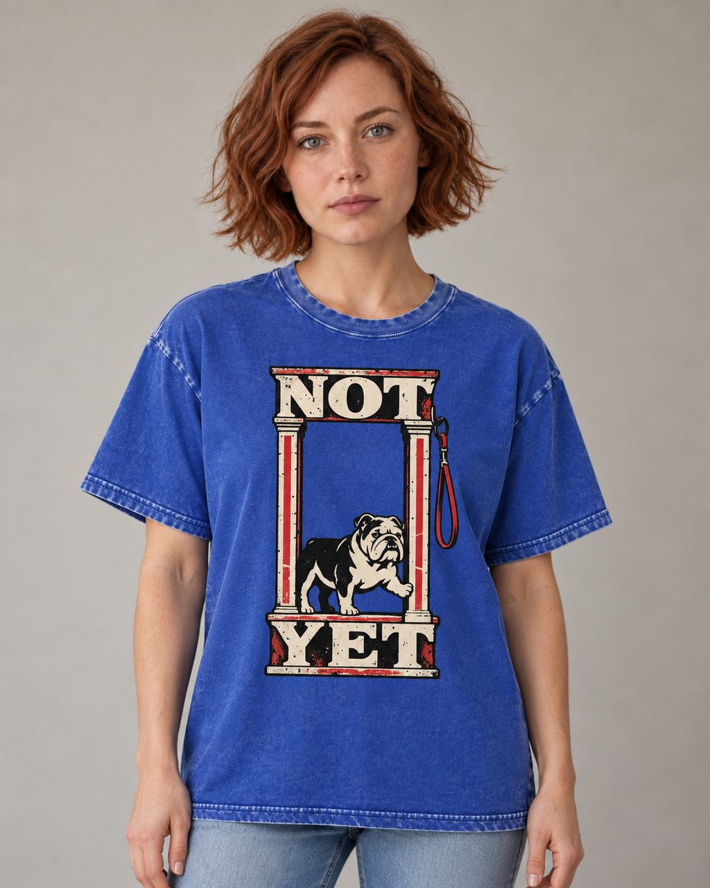 Adult model wears Royal Blue English Bulldog Not Yet Doorway washed T-shirt in a warm studio portrait