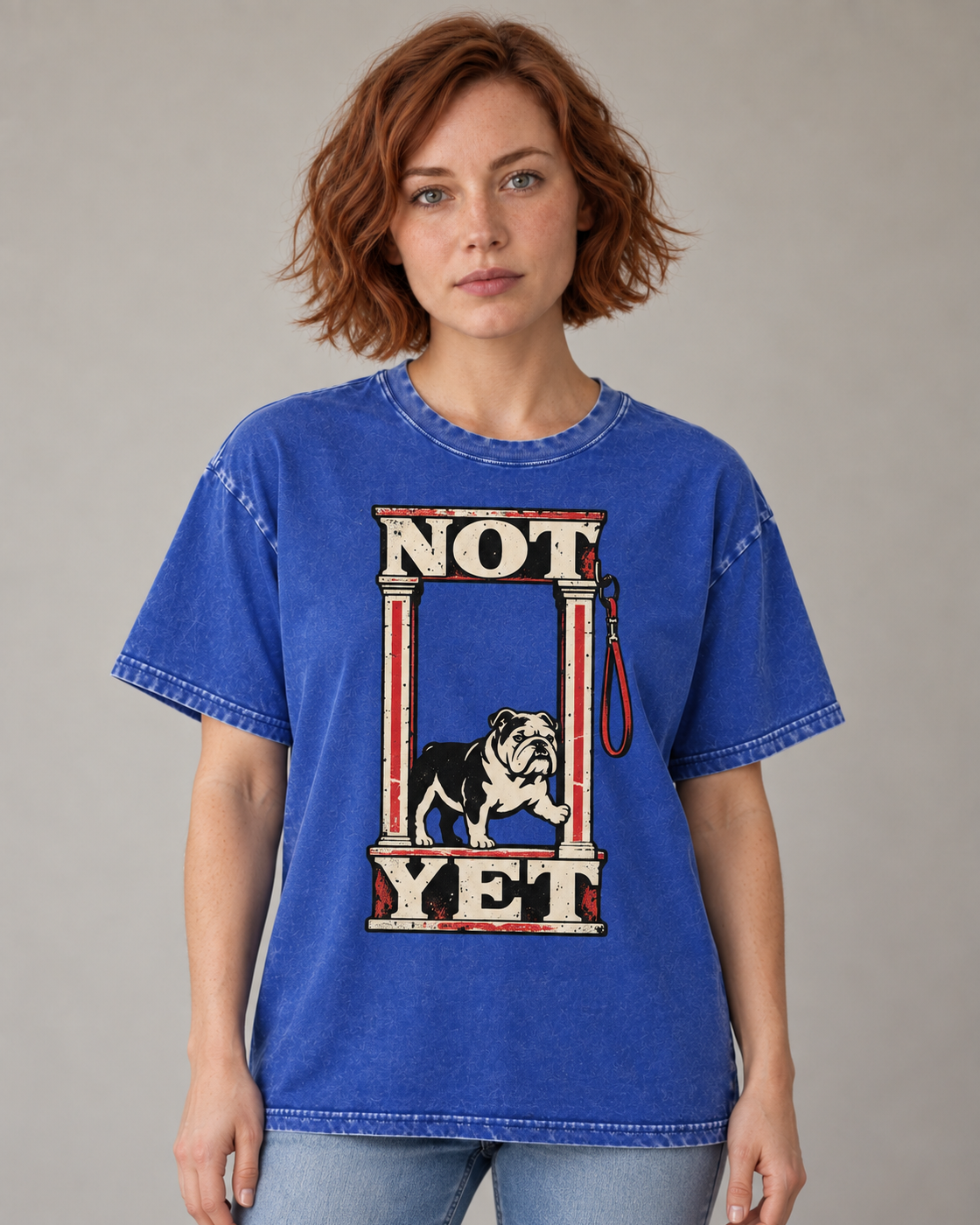 Adult model wears Royal Blue English Bulldog Not Yet Doorway washed T-shirt in a warm studio portrait