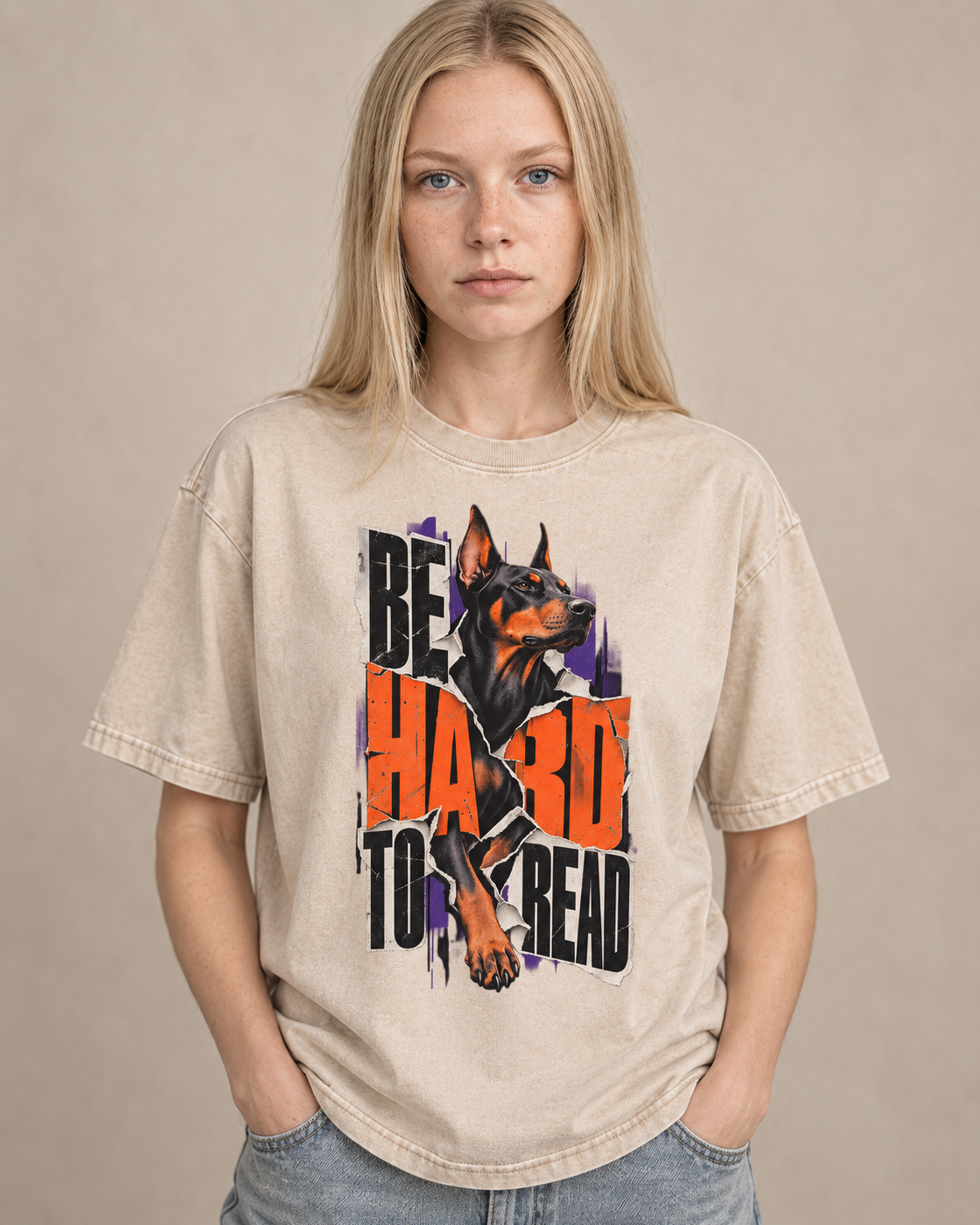 Adult model wears Apricot Doberman Be Hard to Read Torn Poster washed T-shirt in a warm studio portrait