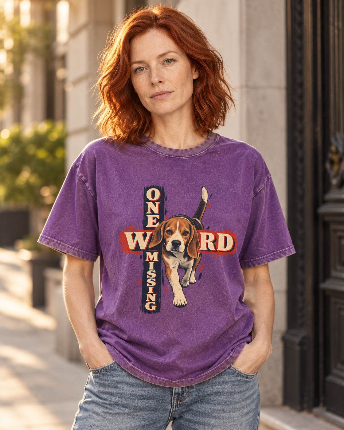 Adult model wears Purple Beagle One Word Missing washed T-shirt in a three-quarter street portrait