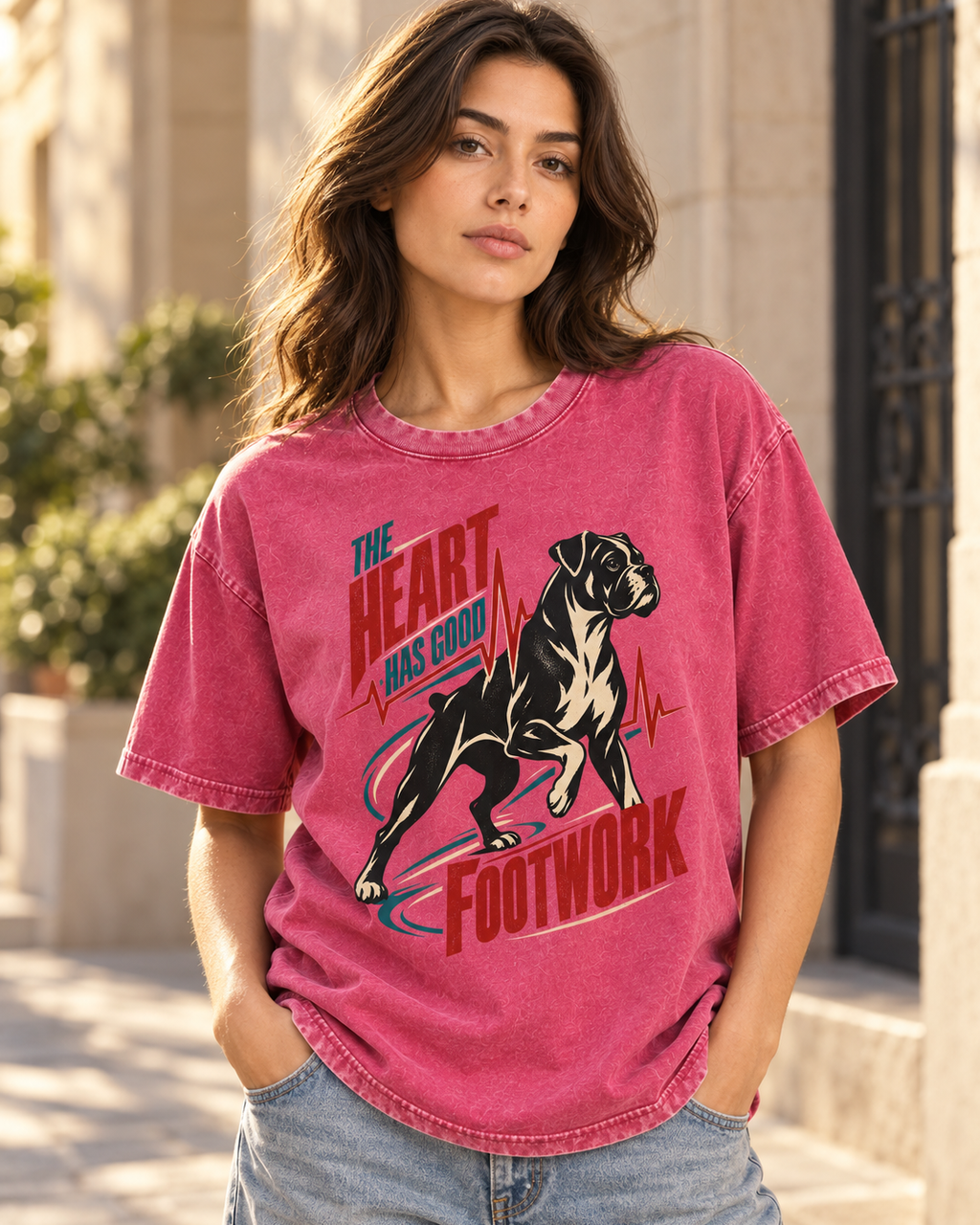Adult model wears Fuchsia Boxer The Heart Has Good Footwork ECG Motion washed T-shirt in a three-quarter street portrait
