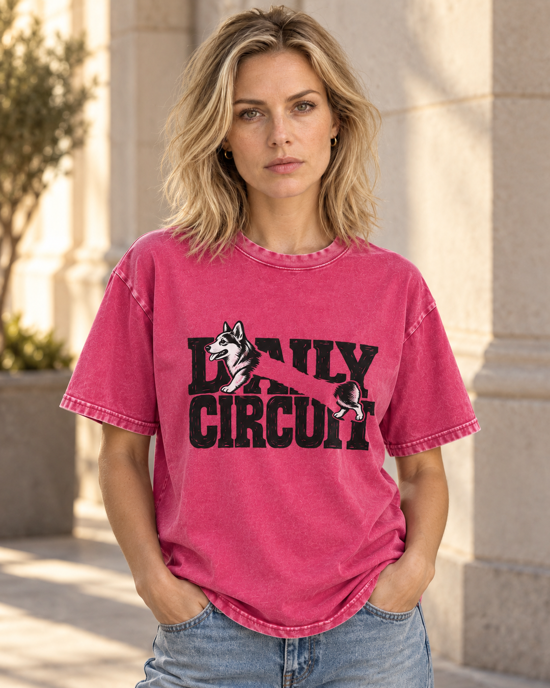 Adult model wears Fuchsia Corgi Family Circuit Running Letterpress washed T-shirt in a three-quarter street portrait