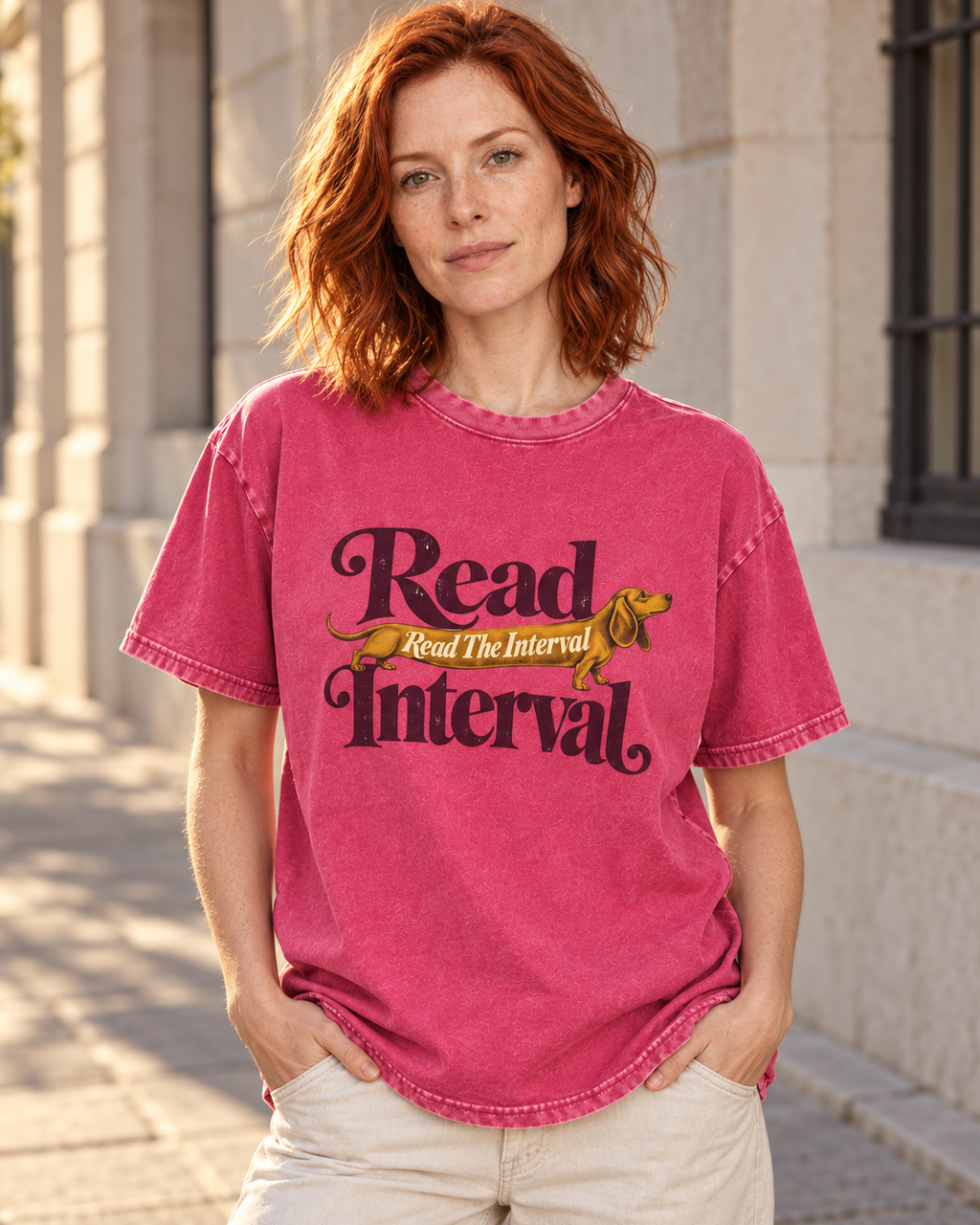 Adult model wears Fuchsia Dachshund Read The Interval Typographic washed T-shirt in a three-quarter street portrait