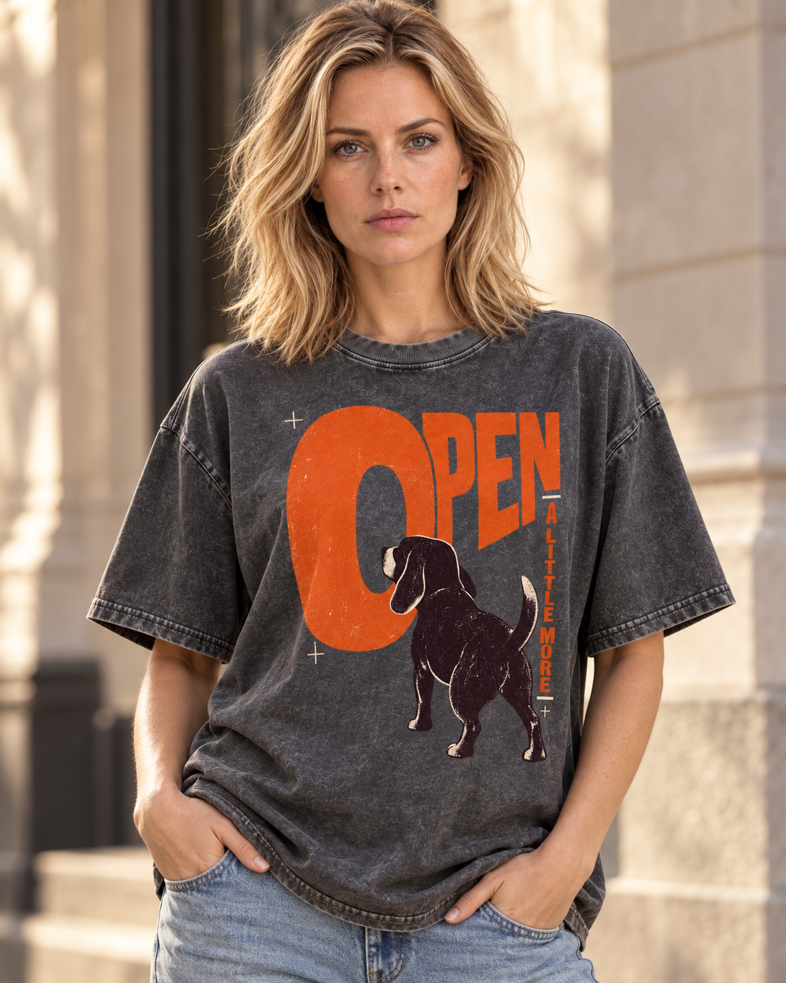 Adult model wears Gray Beagle Open A Little More washed T-shirt in a three-quarter street portrait