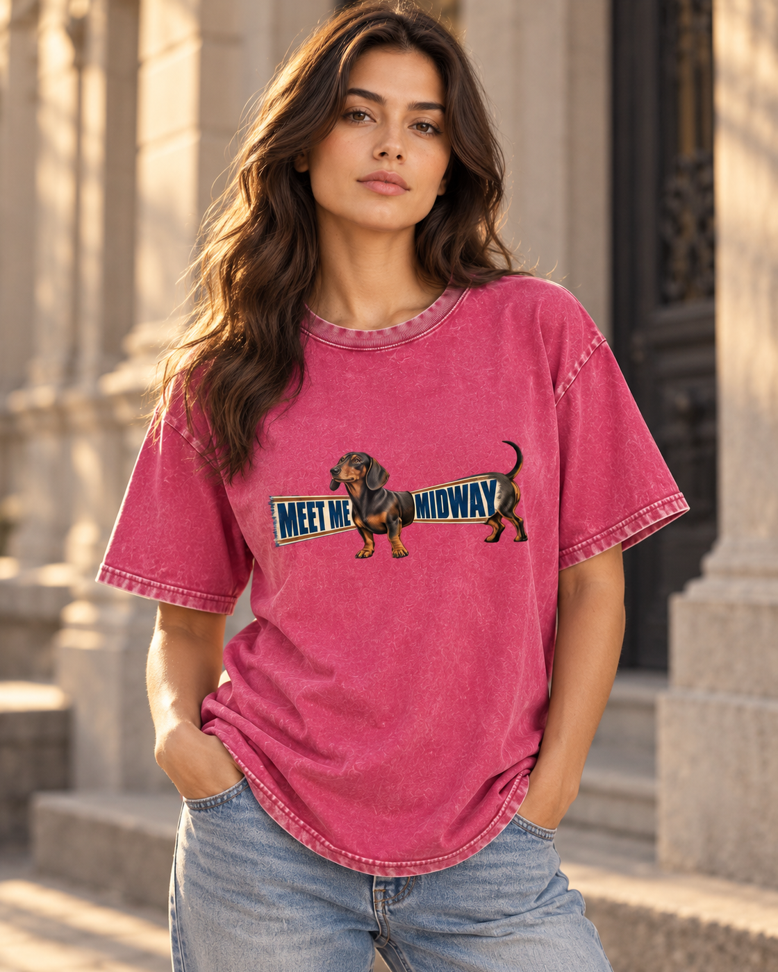 Adult model wears Fuchsia Dachshund Meet Me Midway Banner washed T-shirt in a three-quarter street portrait