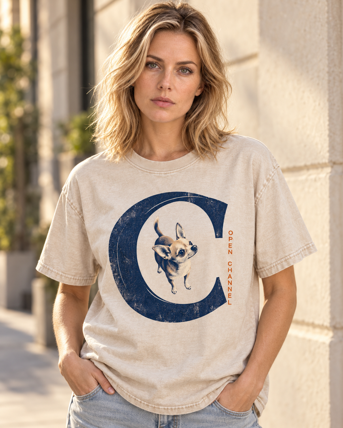 Adult model wears Apricot Chihuahua Open Channel washed T-shirt in a three-quarter street portrait