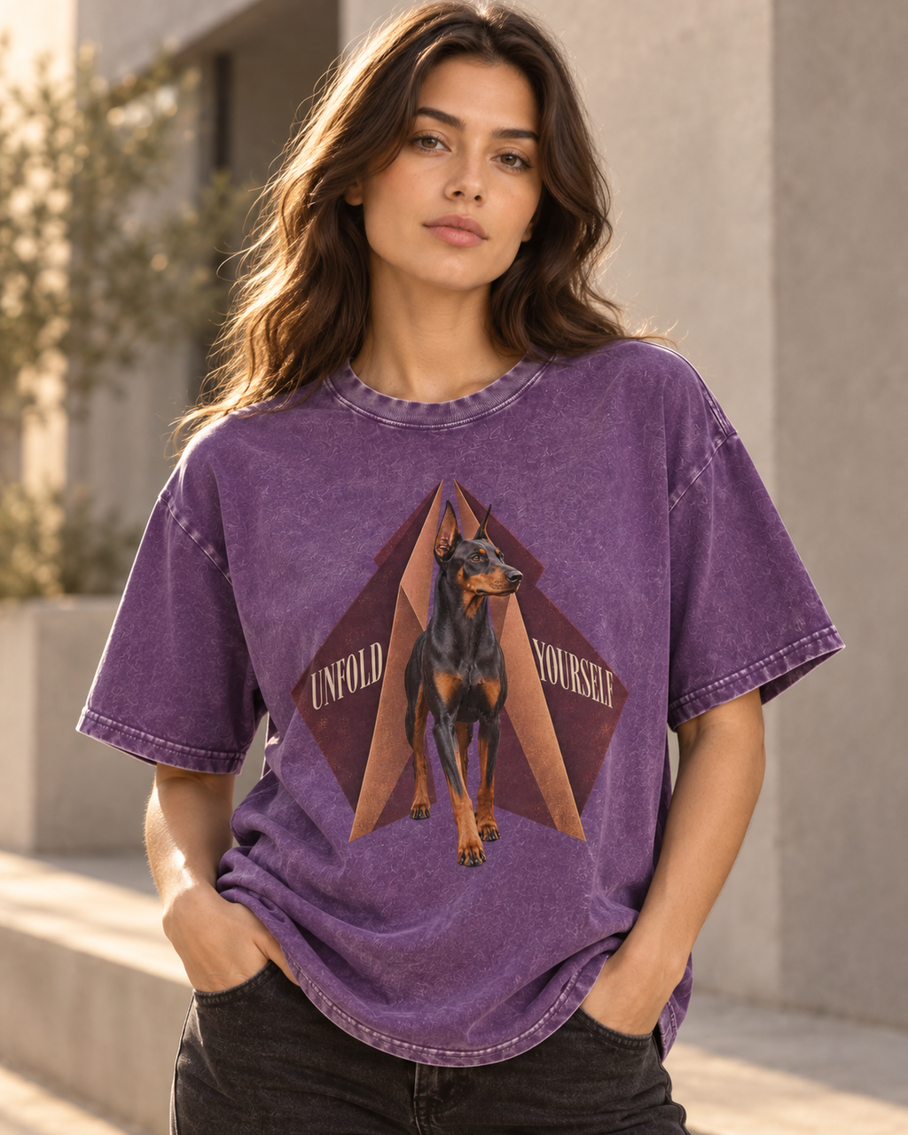 Adult model wears Purple Doberman Unfold Yourself Geometric Portrait washed T-shirt in a three-quarter street portrait