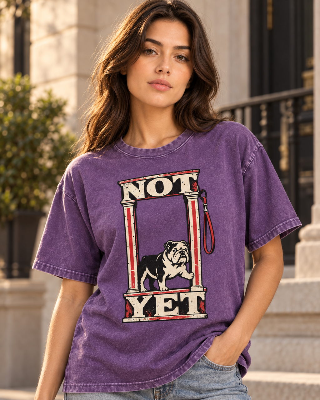 Adult model wears Purple English Bulldog Not Yet Doorway washed T-shirt in a three-quarter street portrait