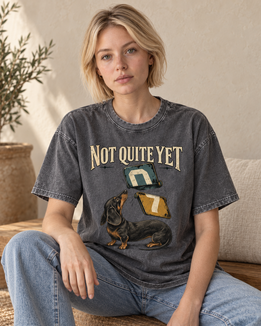 Adult model wears Gray Dachshund Not Quite Yet Flip Cards washed T-shirt in a seated indoor portrait
