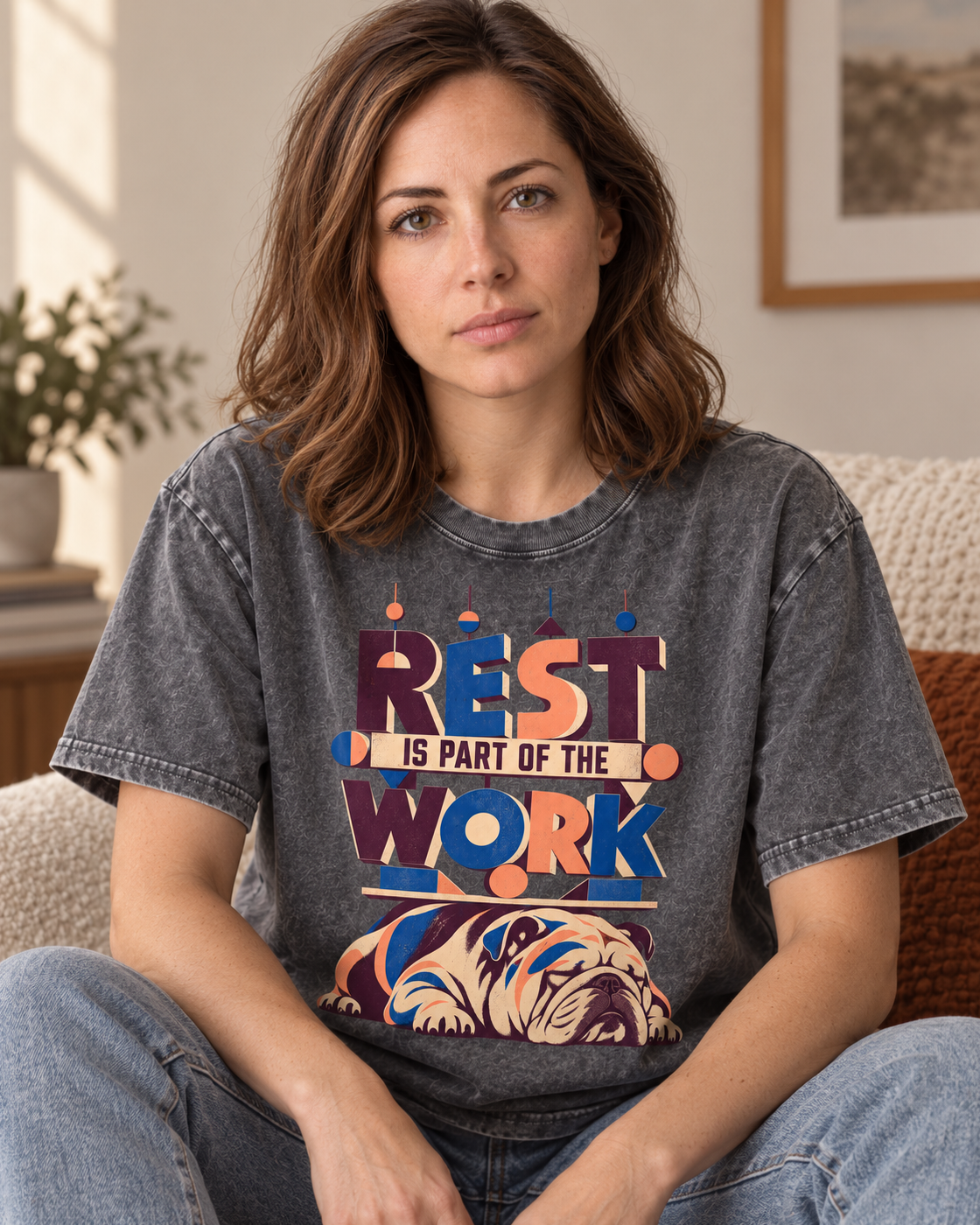 Adult model wears Gray English Bulldog Rest Is Part of the Work Geometric washed T-shirt in a seated indoor portrait