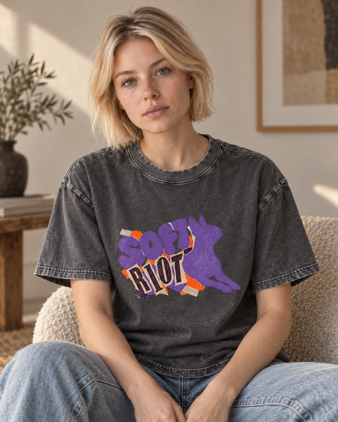 Adult model wears Gray Boston Terrier Soft Riot washed T-shirt in a seated indoor portrait