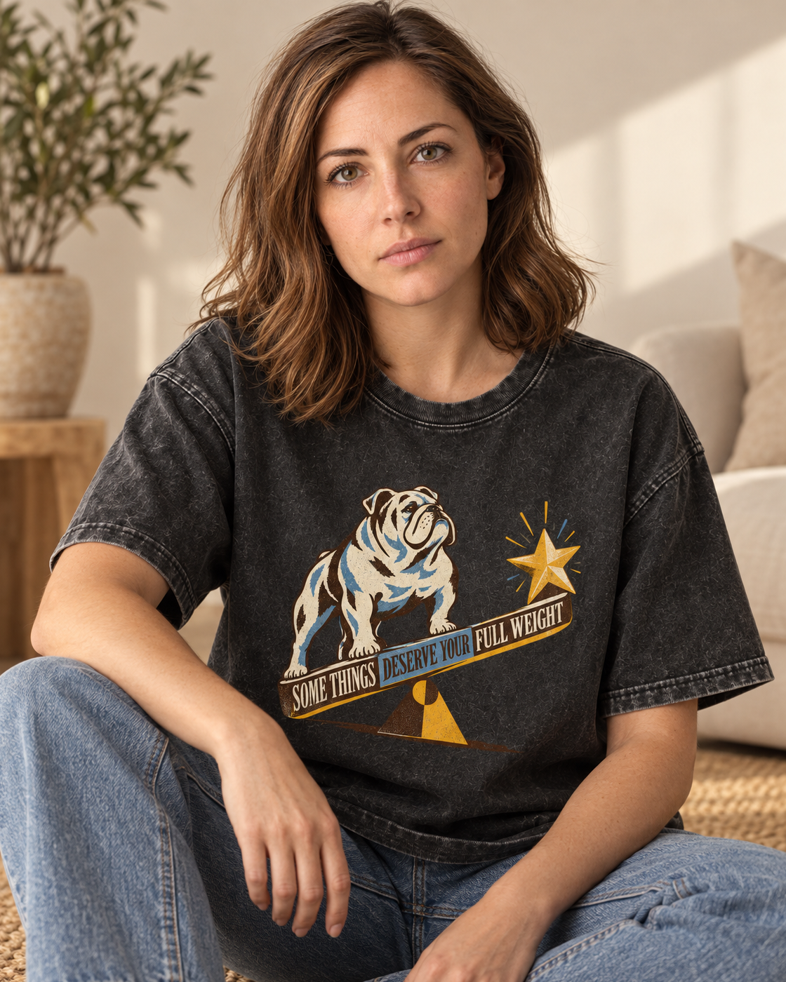 Adult model wears Black English Bulldog Some Things Deserve Your Full Weight washed T-shirt in a seated indoor portrait