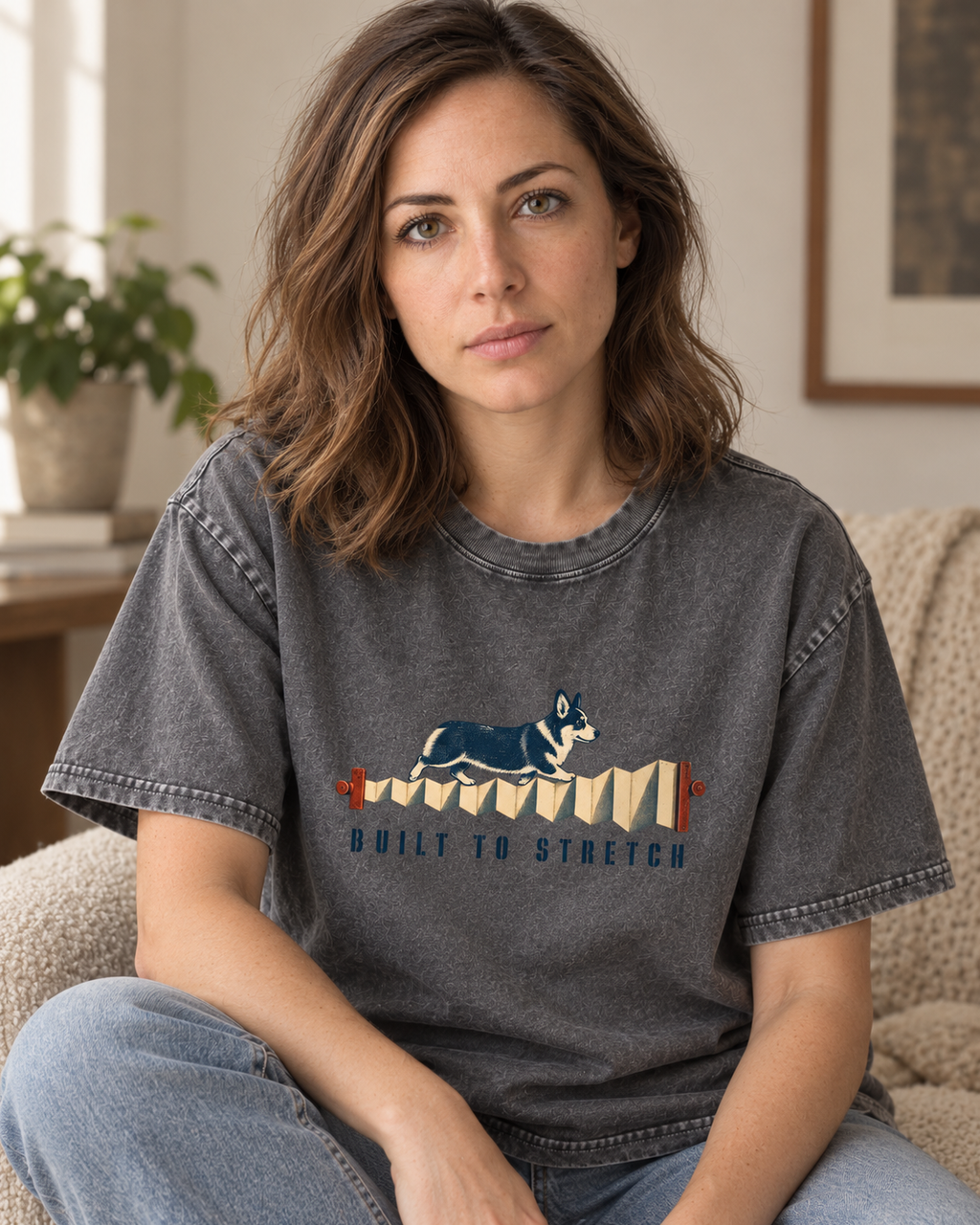 Adult model wears Gray Corgi Built to Stretch Accordion washed T-shirt in a seated indoor portrait