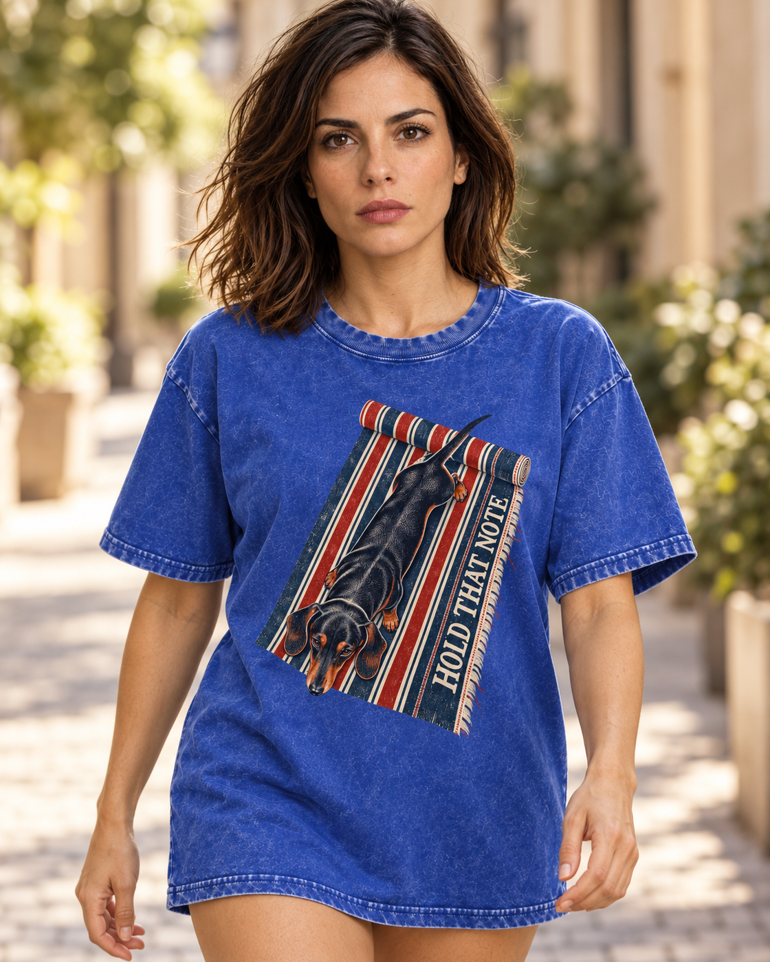 Adult model wears Royal Blue Dachshund Hold That Note Striped Rug washed T-shirt in a natural walking portrait