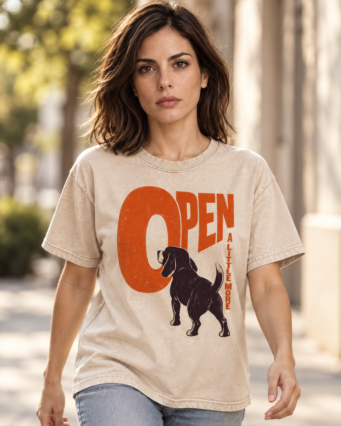 Adult model wears Apricot Beagle Open A Little More washed T-shirt in a natural walking portrait