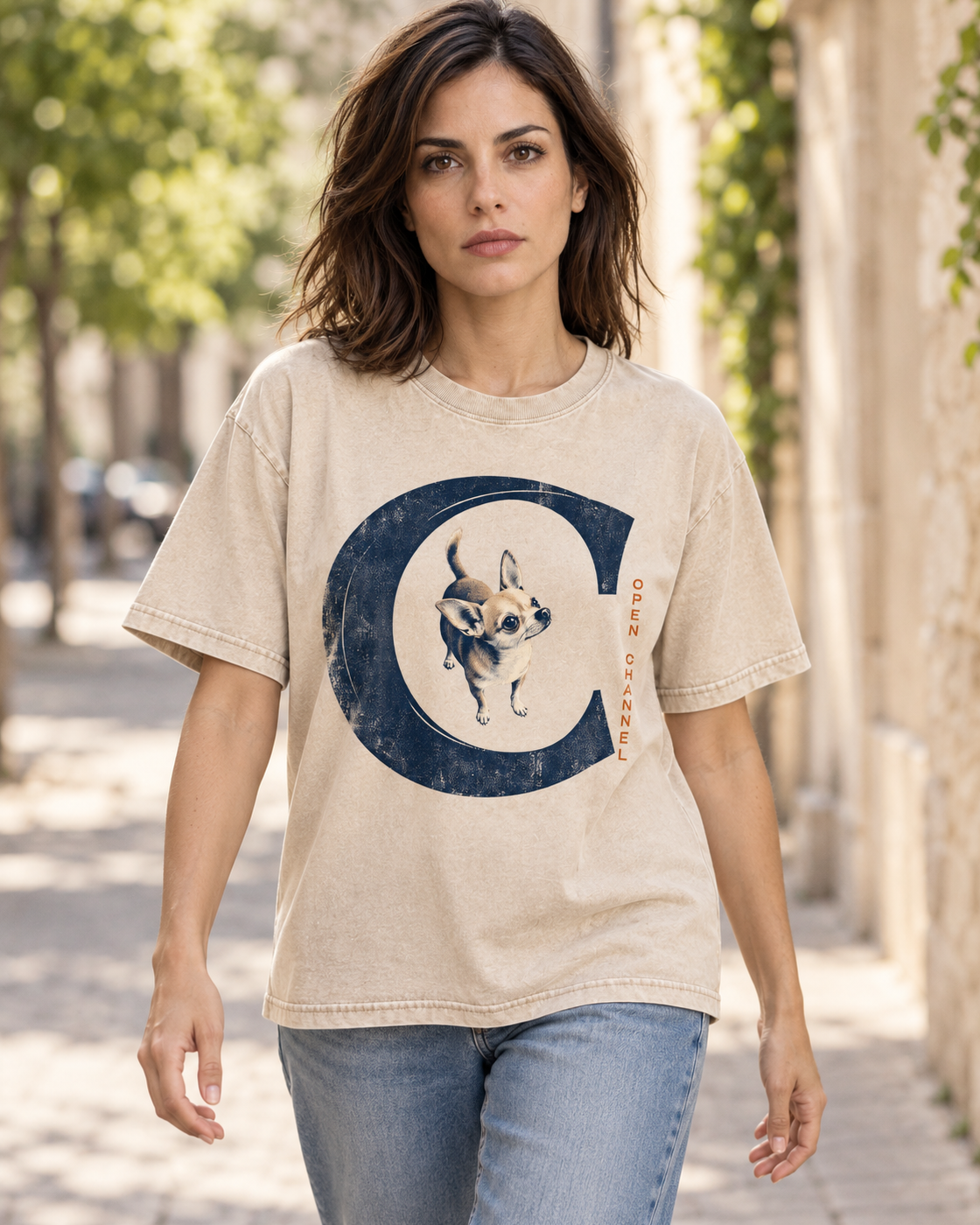 Adult model wears Apricot Chihuahua Open Channel washed T-shirt in a natural walking portrait