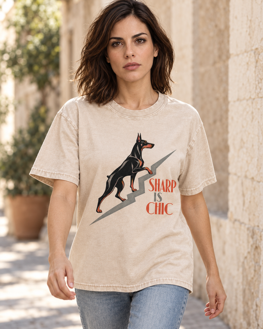 Adult model wears Apricot Doberman Sharp Is Chic Stairway washed T-shirt in a natural walking portrait