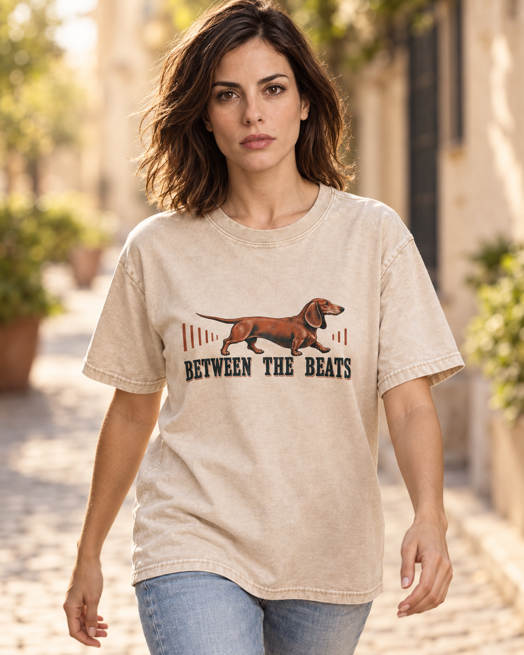 Adult model wears Apricot Dachshund Between The Beats Audio Wave washed T-shirt in a natural walking portrait