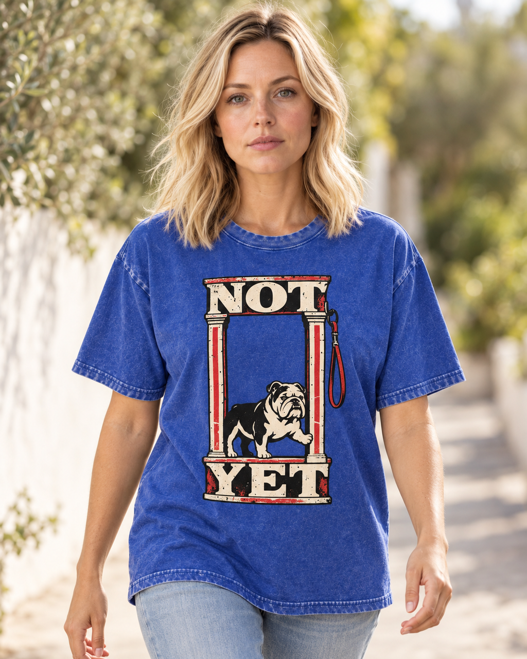 Adult model wears Royal Blue English Bulldog Not Yet Doorway washed T-shirt in a natural walking portrait