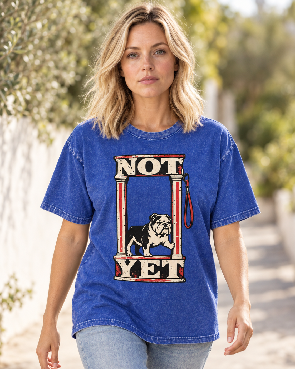 Adult model wears Royal Blue English Bulldog Not Yet Doorway washed T-shirt in a natural walking portrait