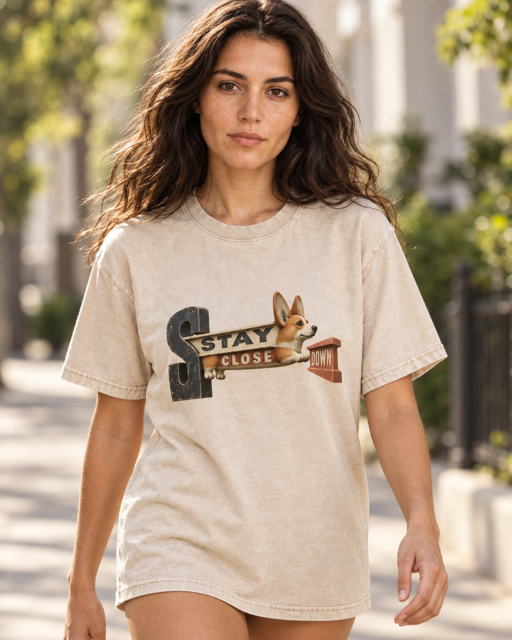 Adult model wears Apricot Corgi Stay Close Down Sign washed T-shirt in a natural walking portrait