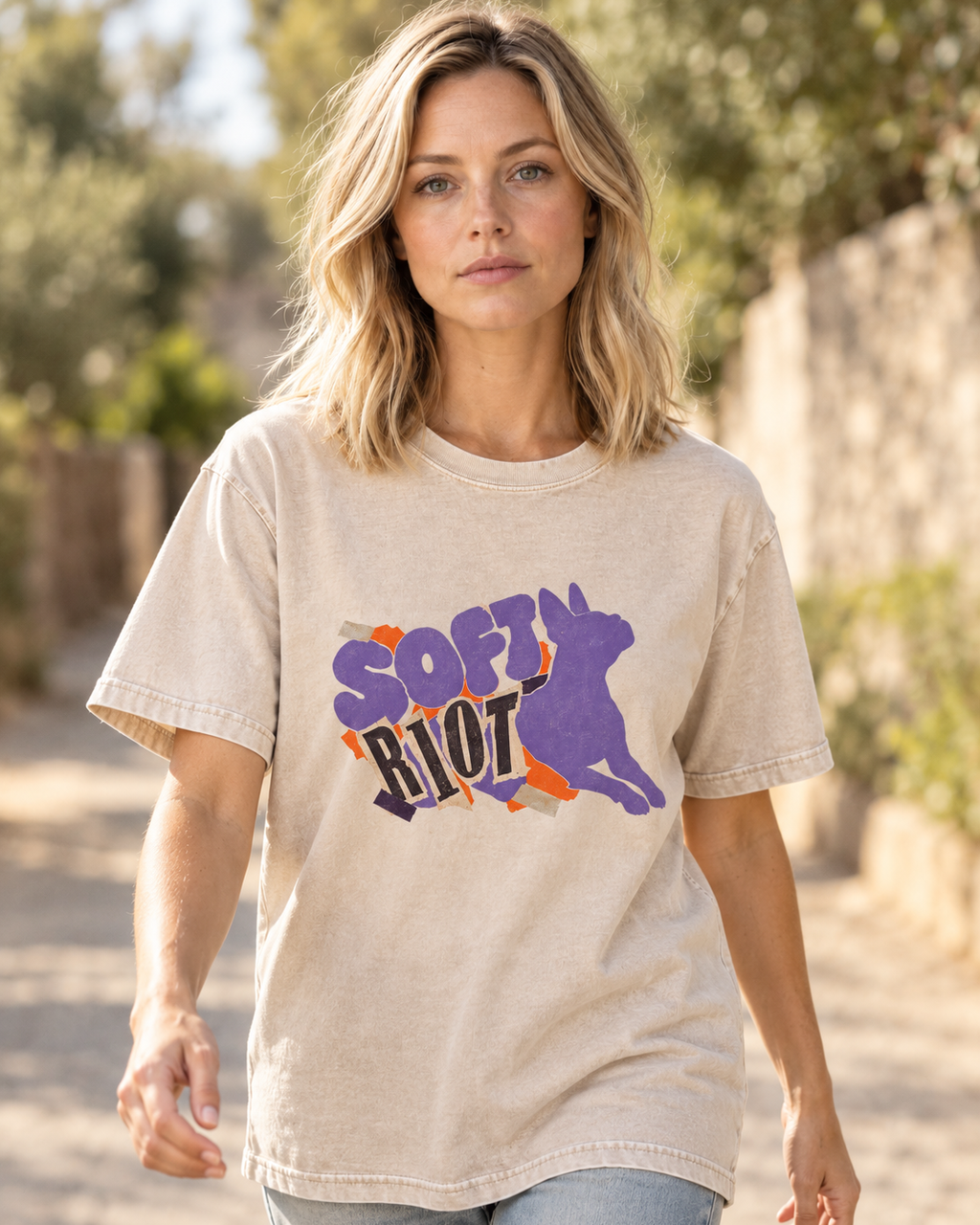 Adult model wears Apricot Boston Terrier Soft Riot washed T-shirt in a natural walking portrait