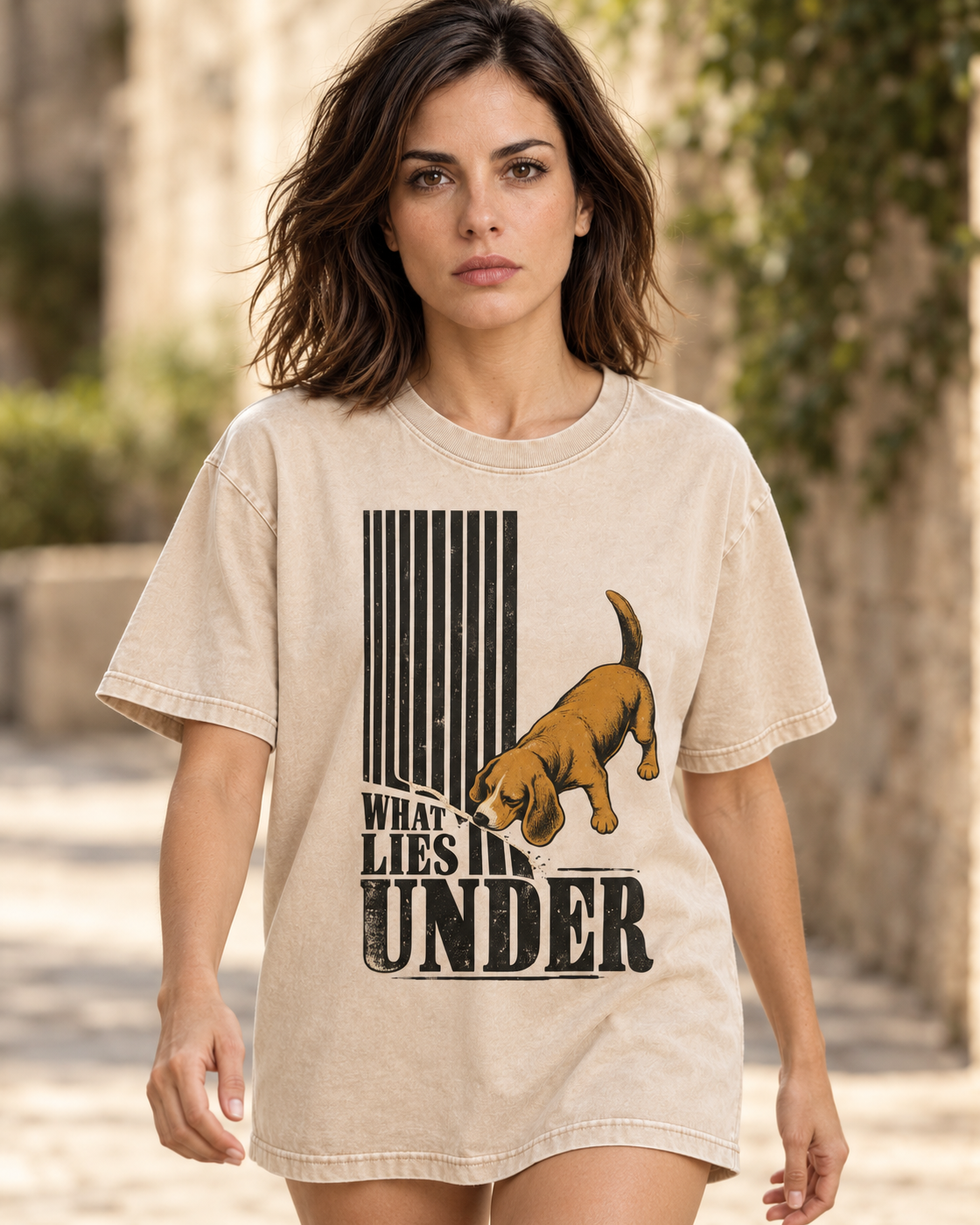 Adult model wears Apricot Beagle Curious What Lies Under washed T-shirt in a natural walking portrait