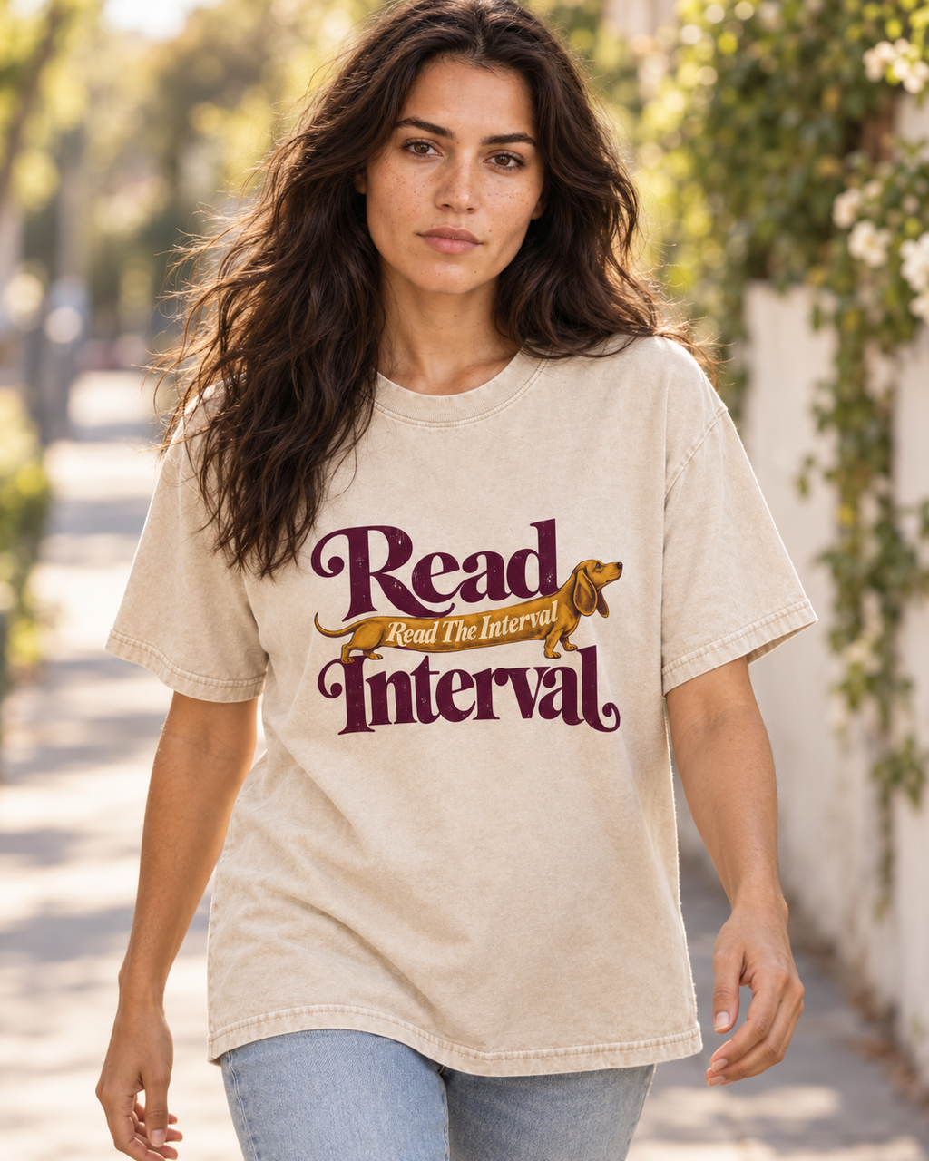 Adult model wears Apricot Dachshund Read The Interval Typographic washed T-shirt in a natural walking portrait