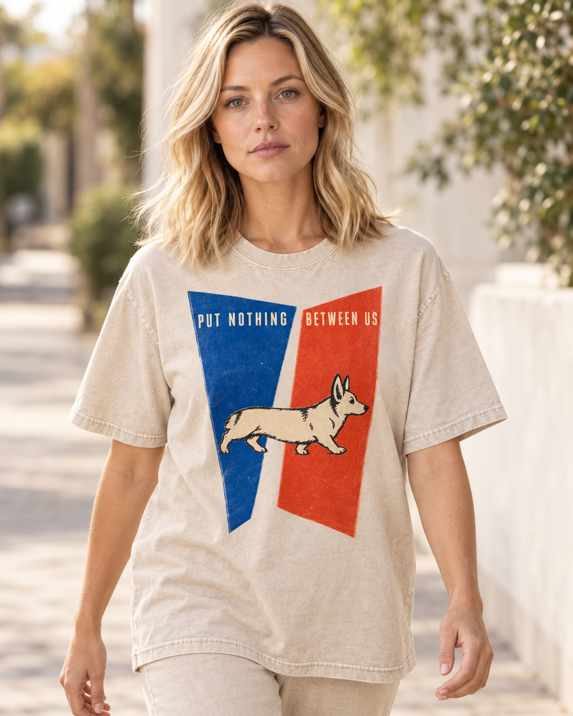 Adult model wears Apricot Corgi Put Nothing Between Us Split Panels washed T-shirt in a natural walking portrait