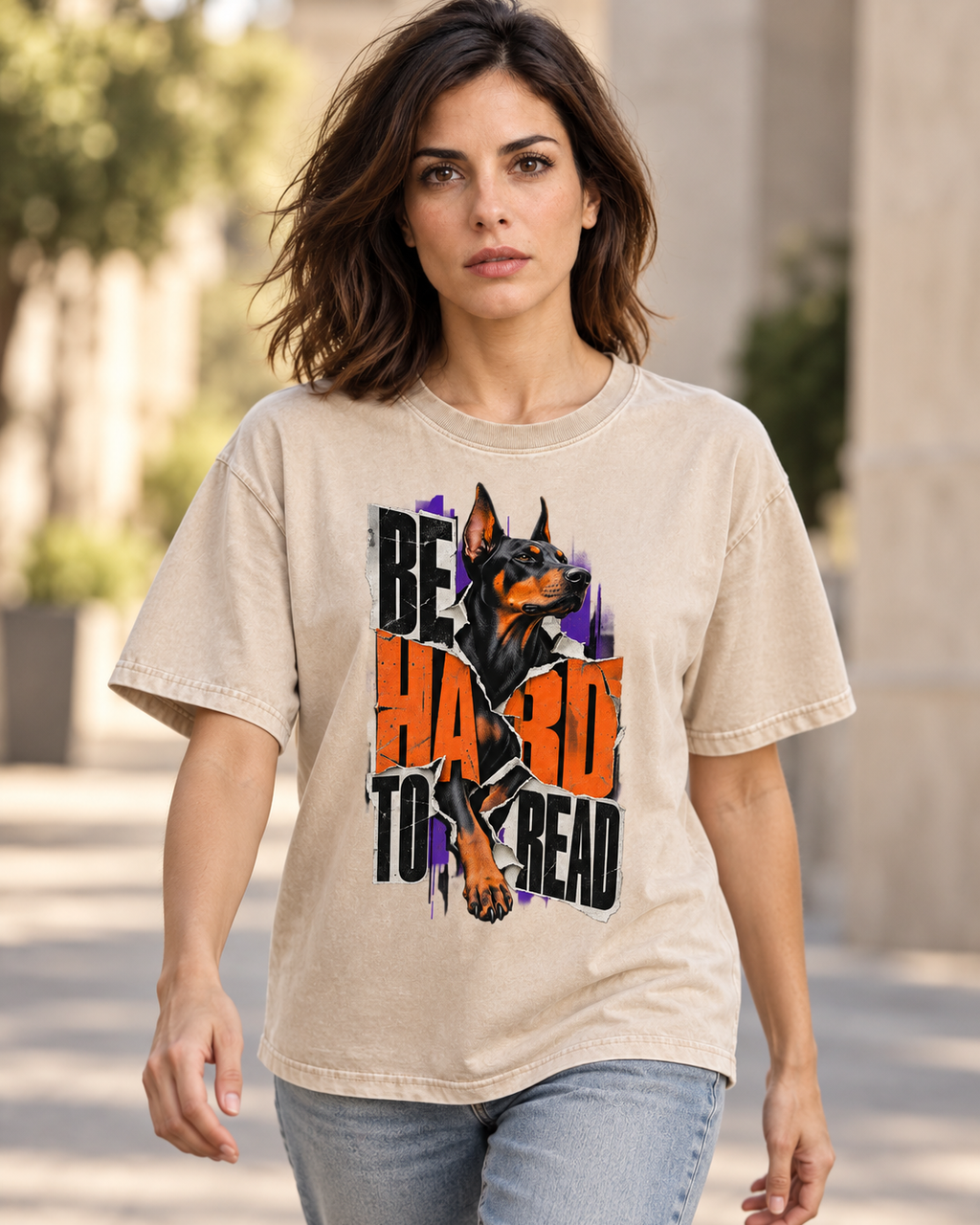 Adult model wears Apricot Doberman Be Hard to Read Torn Poster washed T-shirt in a natural walking portrait