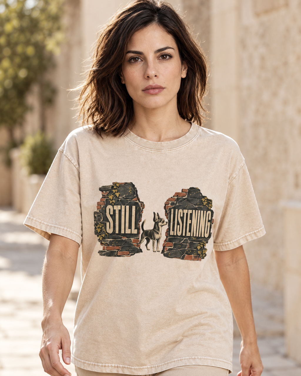 Adult model wears Apricot Chihuahua Still Listening washed T-shirt in a natural walking portrait