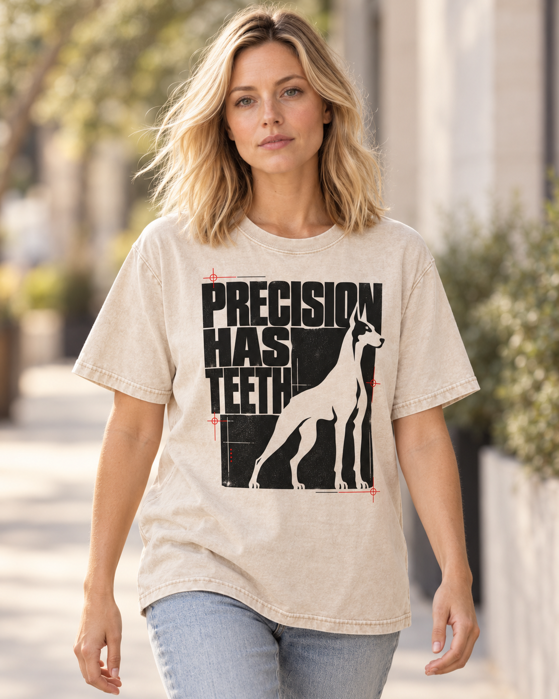 Adult model wears Apricot Doberman Precision Has Teeth washed T-shirt in a natural walking portrait