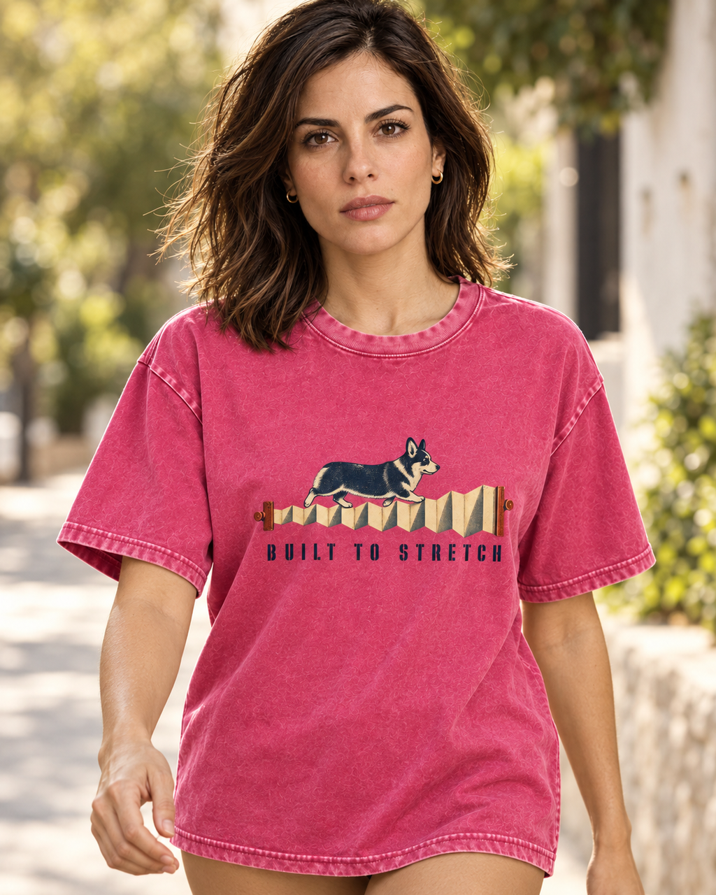 Adult model wears Fuchsia Corgi Built to Stretch Accordion washed T-shirt in a natural walking portrait