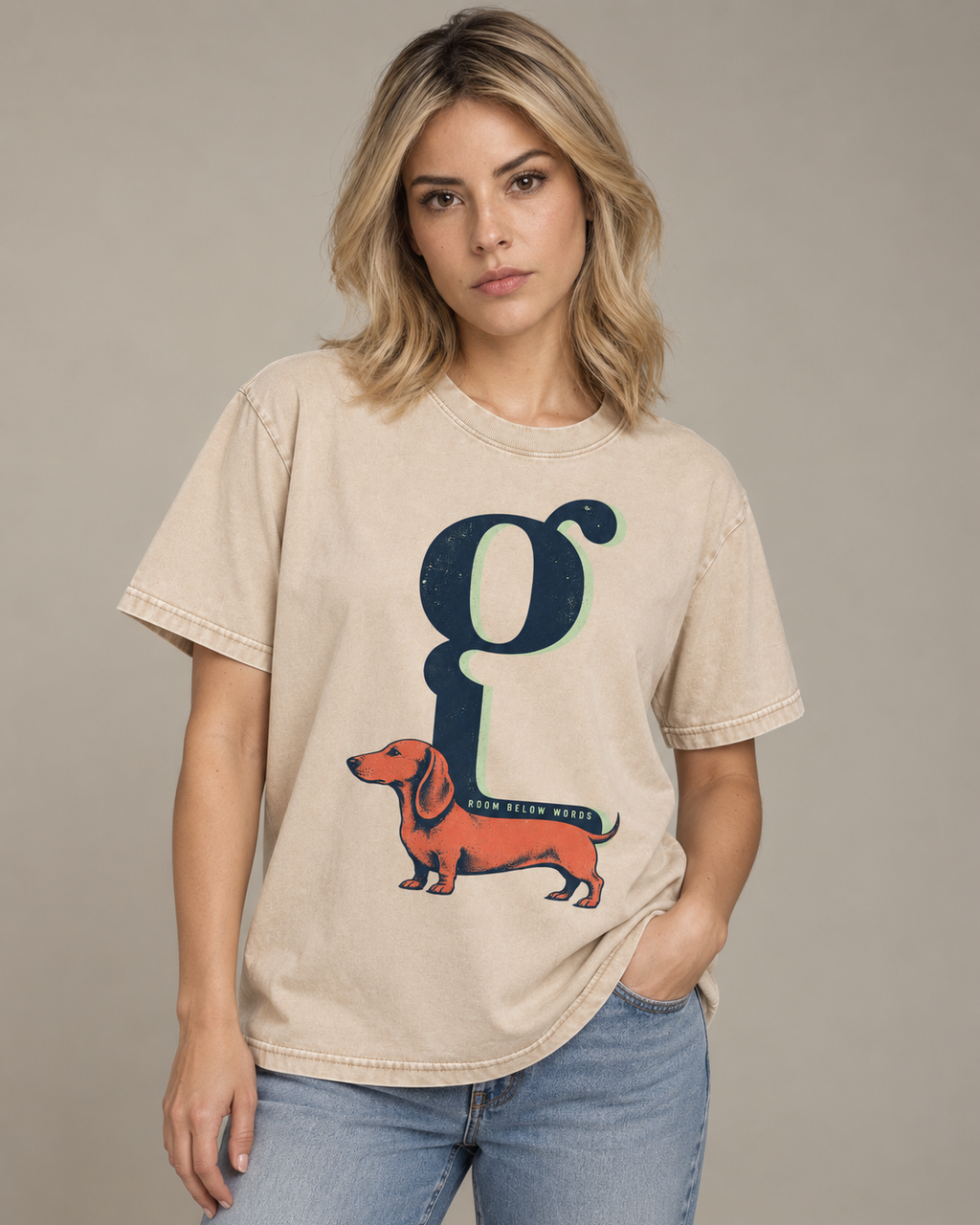Adult model wears Apricot Dachshund Room Below Words Lowercase G washed T-shirt in a side-angle editorial portrait