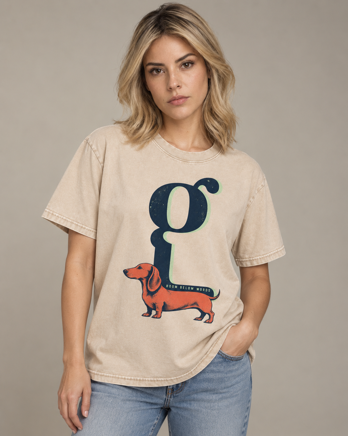 Adult model wears Apricot Dachshund Room Below Words Lowercase G washed T-shirt in a side-angle editorial portrait