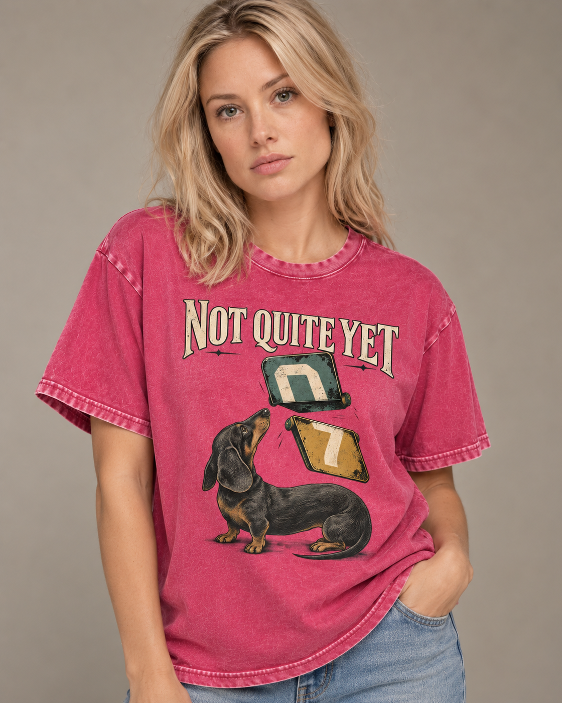 Adult model wears Fuchsia Dachshund Not Quite Yet Flip Cards washed T-shirt in a side-angle editorial portrait